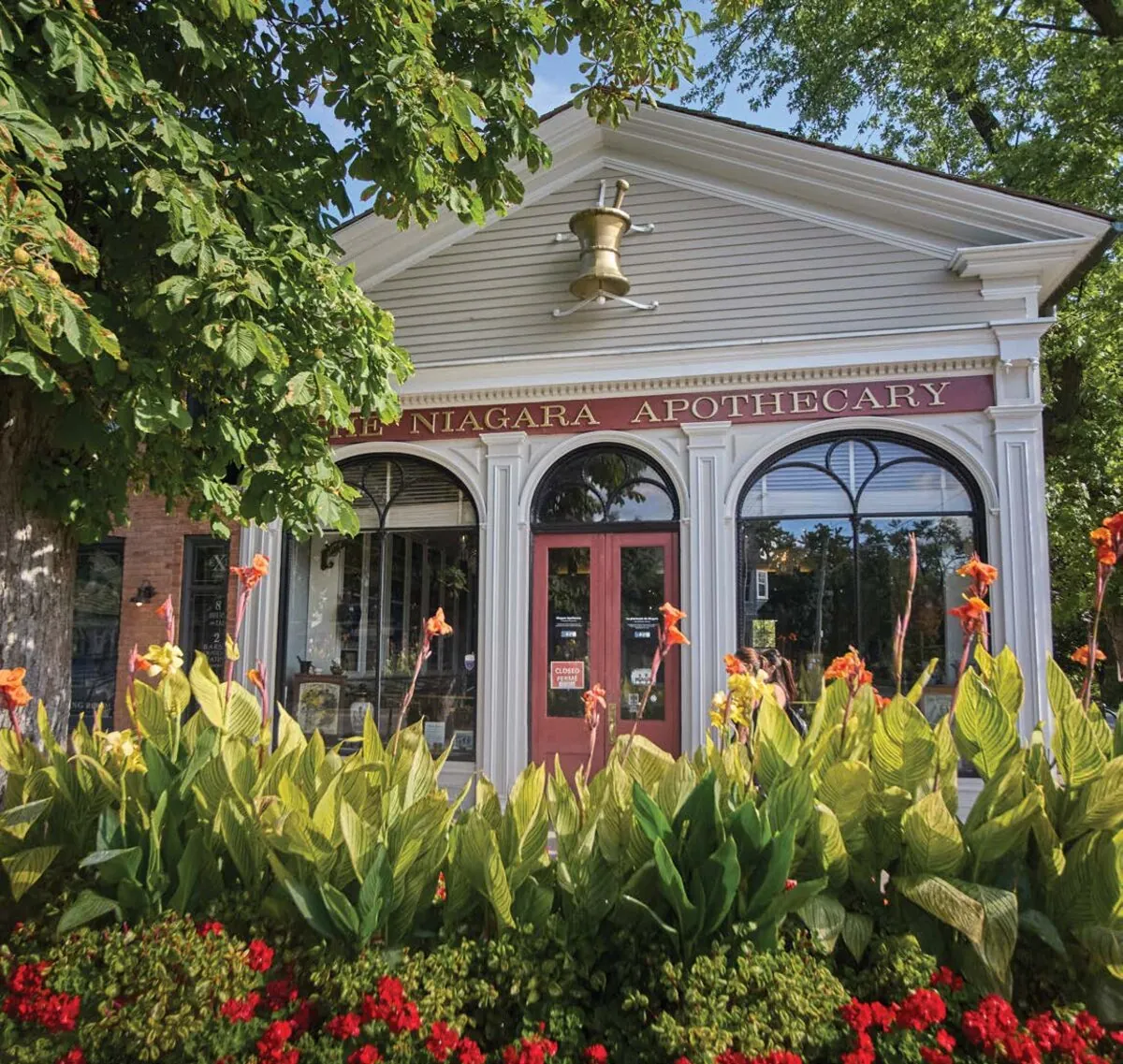 Historic storefront in Niagara-on-the-Lake surrounded by flowers, a 28 minute drive from Wellwood